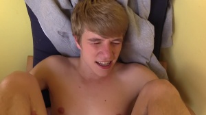 Czech lad with good blond hair pokes in a park